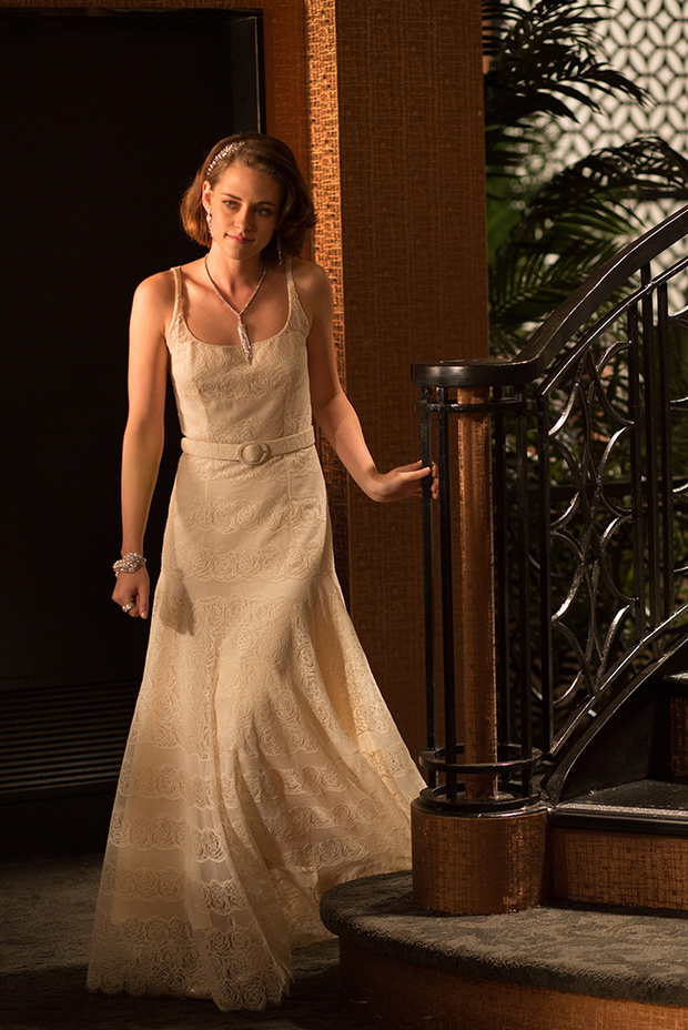 A still from "Cafe Society" showing Kristen Stewart in a custom-made off-white silk and lace Chanel dress and Chanel fine jewelry