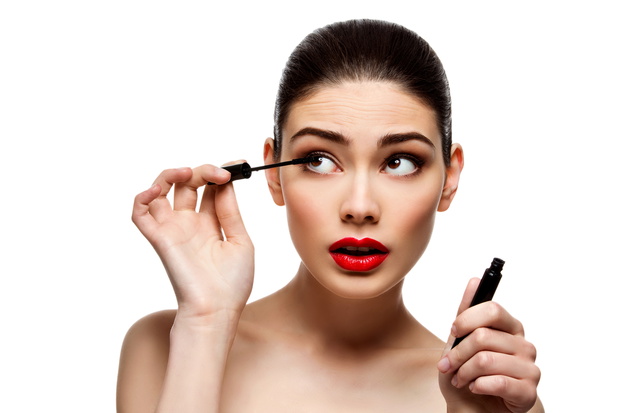 Beautiful girl with mascara tube