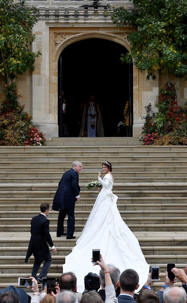 Britain's Princess Eugenie arrives accompanied by her father Prince Andrew, Duke of York, at St George's Chapel for her wedding to Jack Brooksbank in Windsor Castle, Windsor