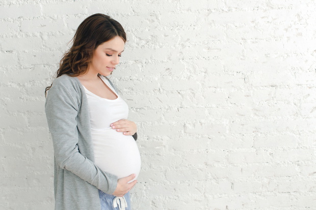 Pregnant woman touching belly
