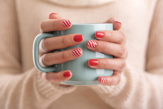 Women's hands holding a cup of drink.