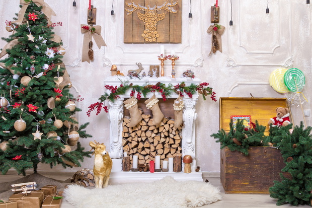Beautiful holdiay decorated room with Christmas tree with presents under it