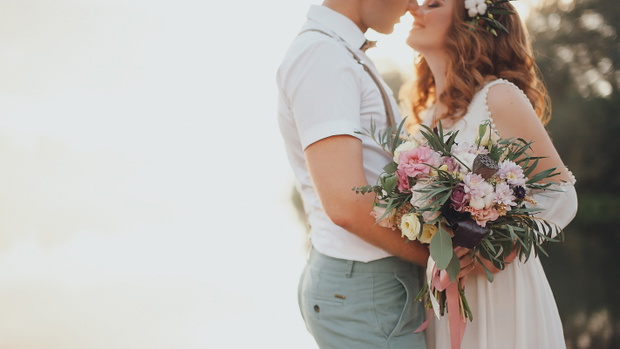 the bride and groom on the background of a mountain stream