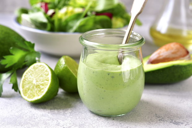 Homemade avocado yogurt dressing in a vintage glass jar.