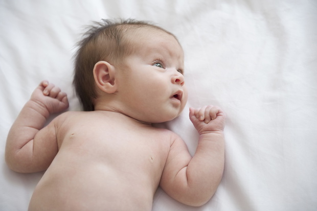 Curious Hispanic newborn baby girl