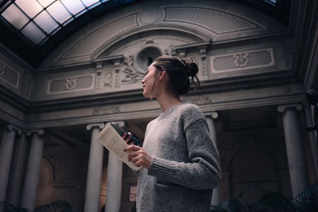 Portrait of a young attractive woman visiting museum or gallery