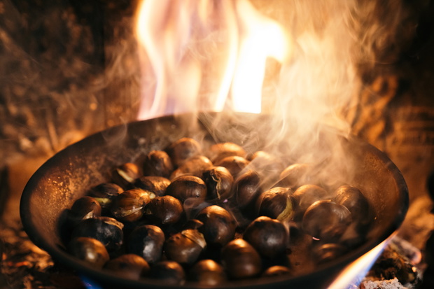 Chestnuts roasted in the chimney and smoking. Roasting chestnuts