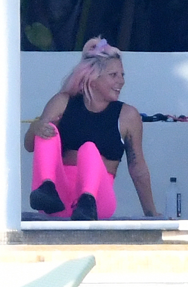 EXCLUSIVE: Lady Gaga works out in pink lycra leggings and a black crop top as she prepares for her pre-Super Bowl concert in Miami.