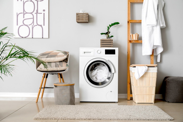 Interior of home laundry room with modern washing machine