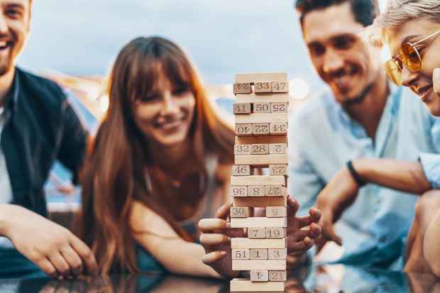The company of young people playing jenga