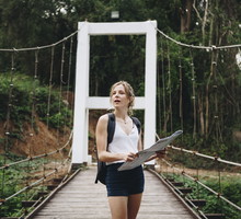 caucasian-woman-looking-at-a-map-travel-and-explor-PPN4K63 (1)