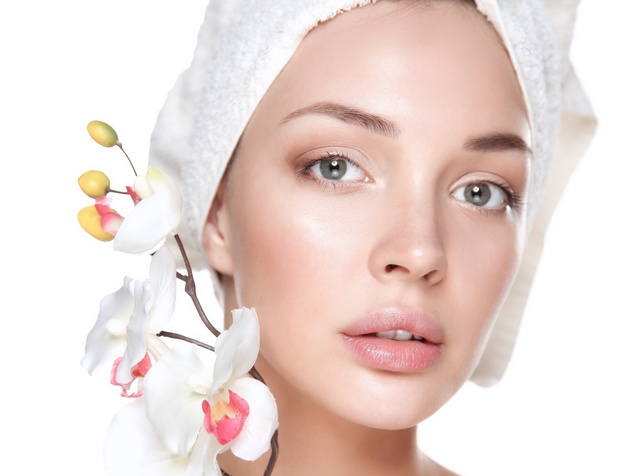 Woman in towel with orchid flowers