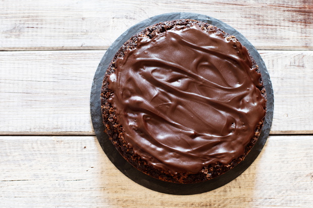 Chocolate brownie cake with ganashe topping on gray background