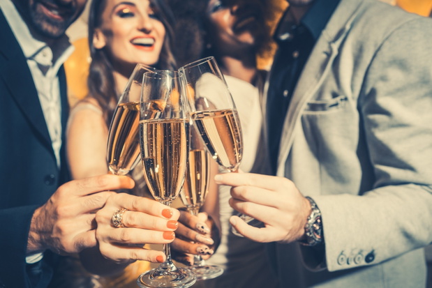Men and women celebrating party while clinking glasses with spar