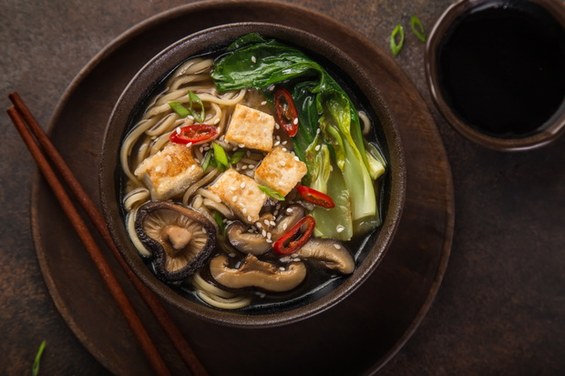 asian vegan noodle soup with tofu cheese, shiitake mushroms and