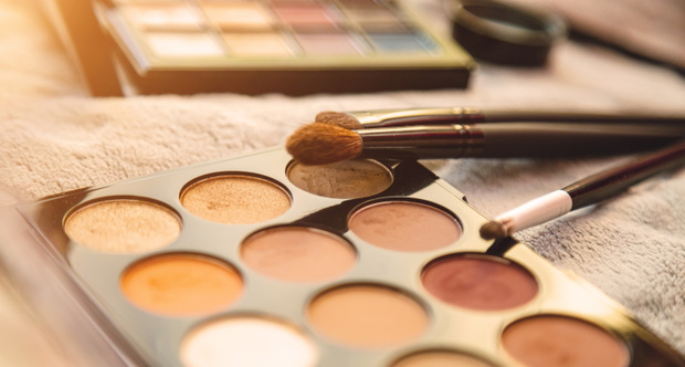 Palette of Multi-colored Cosmetics Eyeshadows and Brushes