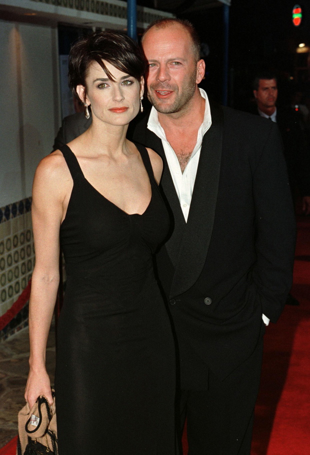 Actress Demi Moore, star of the new film "G.I. Jane," arrives for the film's premiere with husband B..