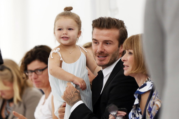 Former England soccer captain David Beckham holds his daughter Harper as he speaks to Vogue editor Anna Wintour while waiting for a presentation of the Victoria Beckham Spring/Summer 2014 collection during New York Fashion Week