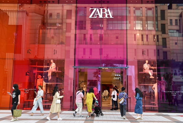 People walk into the Zara shop on Wangfujing Street in