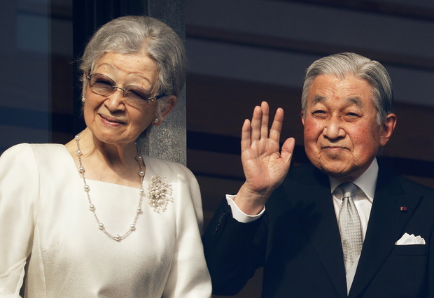 Empress Emerita Michiko and Emperor Emeritus Akihito wave to well-wishers during a public appearance for New Year celebrations at the Imperial Palace in Tokyo