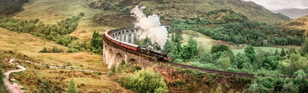 Glenfinnan Railway Viaduct with Jacobite steam train passing ove