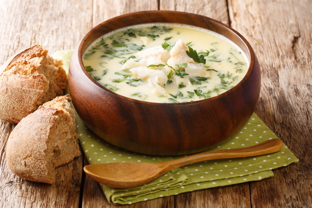 Delicious cream soup cullen skink cooked with smoked haddock and potatoes close-up in a bowl on the table. horizontal