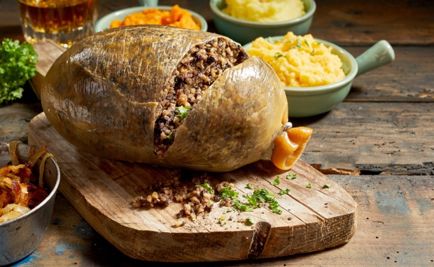 Cooked sliced open haggis and vegetables