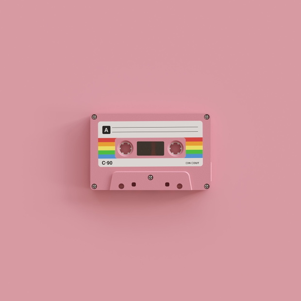 Pink cassette tape with blank label. Front view.