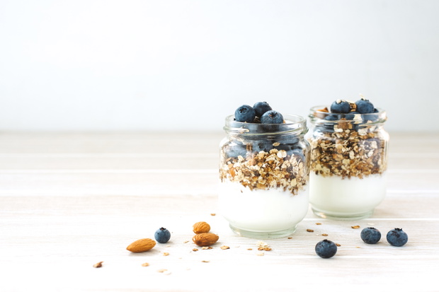 Healthy breakfast in glass jar with yogurt, muesli and blueberri