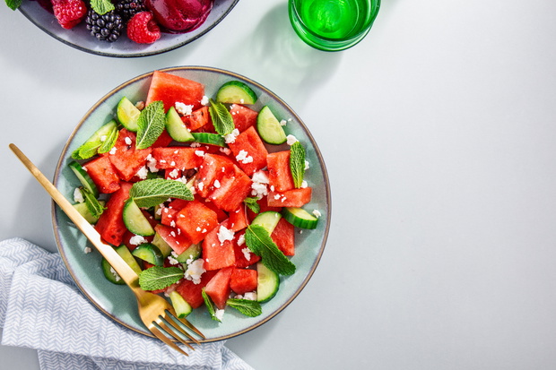 Summer salads with watermelon and cucumbers, berries and ice cre