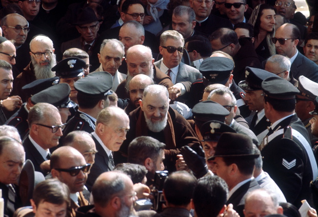 Father Pio from Pietrelcina surrounded by devotees