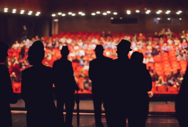 Actors performers on stage and audience waiting for show to star