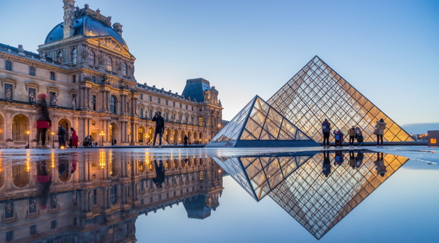iew of famous Louvre Museum with Louvre Pyramid at evening