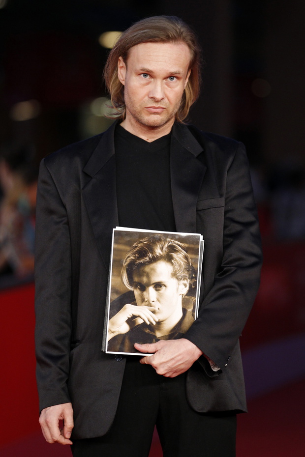 Director Michal Skolimowski holds a picture of his late brother and co-director Jozef as he poses during the red carpet of the movie "Ixjana" at the Rome Film Festival