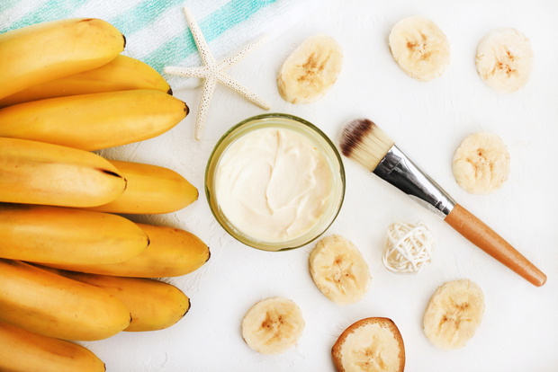 Homemade skincare mask with yummy mashed banana. Jar of cosmetic