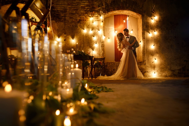 Stylish hipster wedding couple in romantic loft decorations at n
