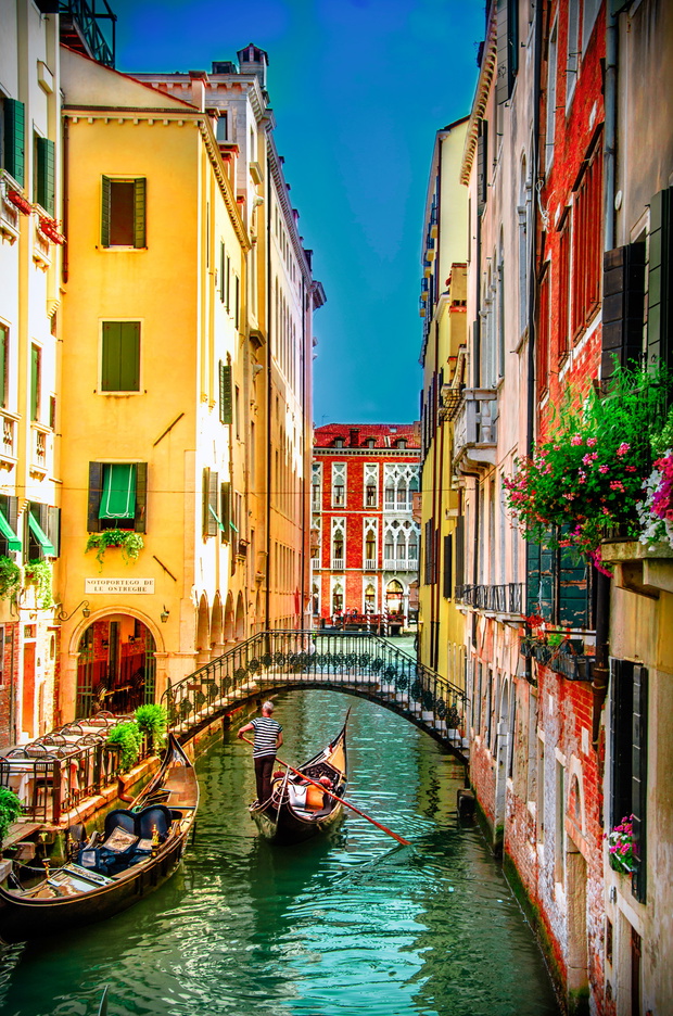 Beautiful scene with traditional gondola and canal in Venice, It