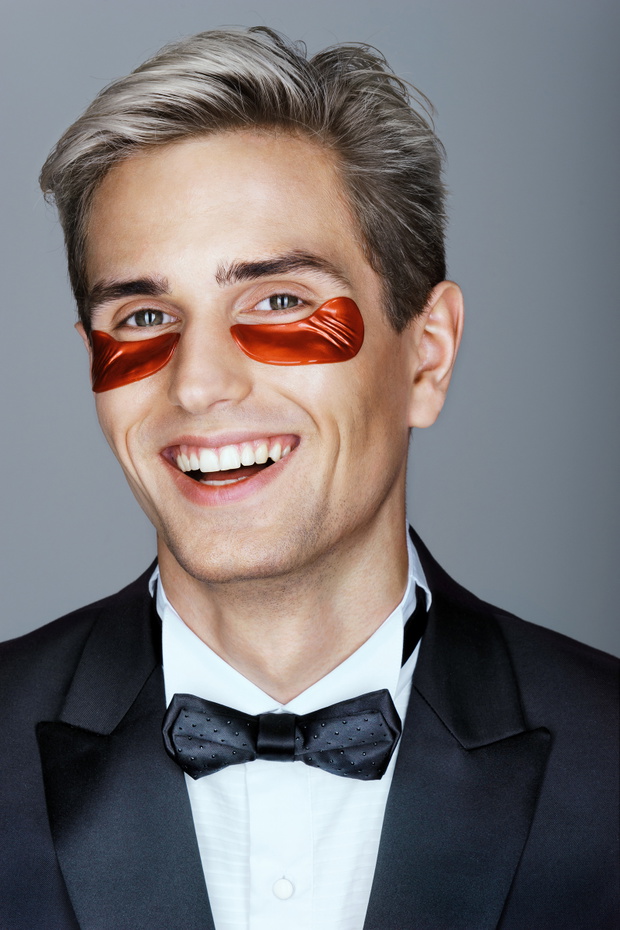 Elegant man with red eye patches. Portrait of smiling man with p