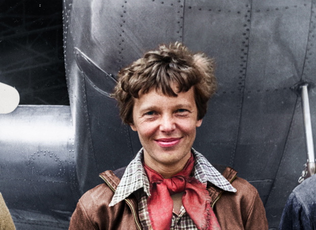 Amelia Earhart standing under nose of her Lockheed Model 10-E Electra. Gelatin silver print, 1937.Photograph by Underwood &amp; Underwood. Location: Cal
