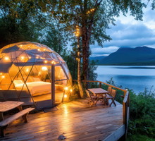 Luxurious glamping dome offers a serene escape with stunning lake and mountain views.
