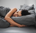 GIrl lying down in bed and sleeping