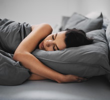 GIrl lying down in bed and sleeping