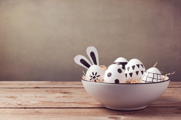 Easter eggs with hand drawing ornament on wooden table