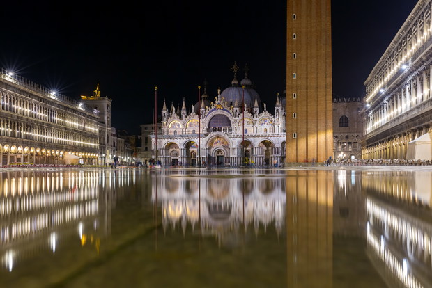 Basilica in San Marco square in Venice with reflection at night during the high tide, or aqua alta, that flooded the square with sea water