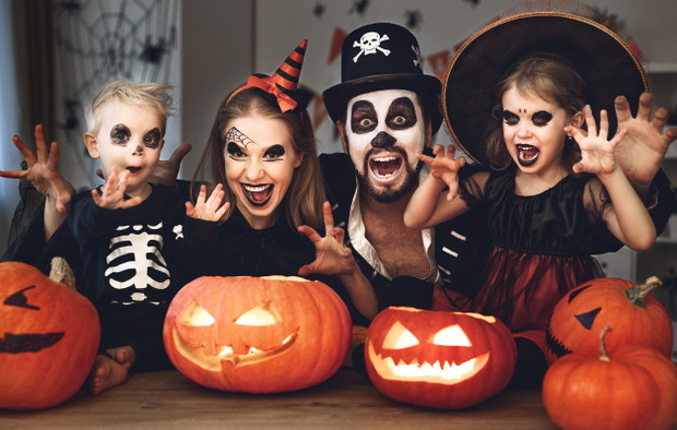 happy family mother father and children in costumes and makeup on  Halloween
