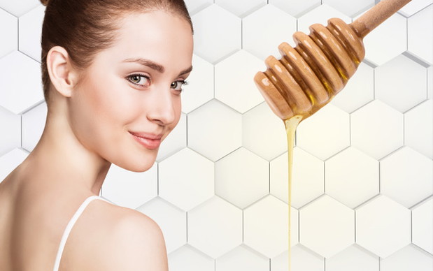 Young woman prepare for honey facial mask.