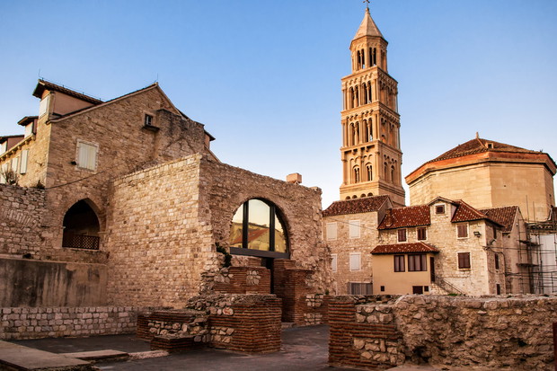 Scene from the old city of Split and the view of old bell tower in sunset