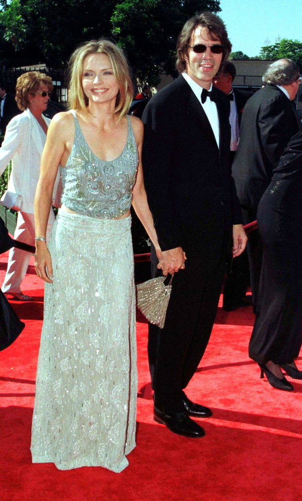 Television producer David E. Kelley and wife, actress Michelle Pfeiffer, pose for photographers as ..