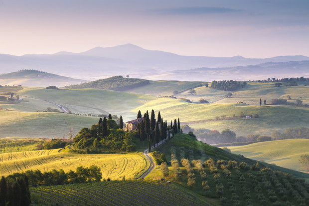 A lonely farmhouse between tuscan rolling hills. Val d'Orcia, Siena province, Tuscany, Italy