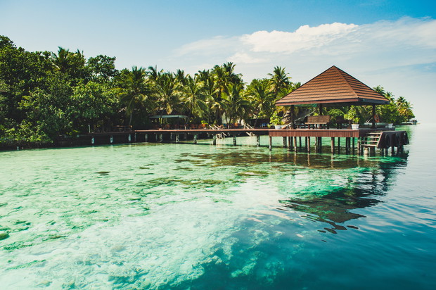 Pier for boat at a tiny amazing and romantic island in Maldives in Laccadive sea in Indian ocean entrance to a tropical paradise
